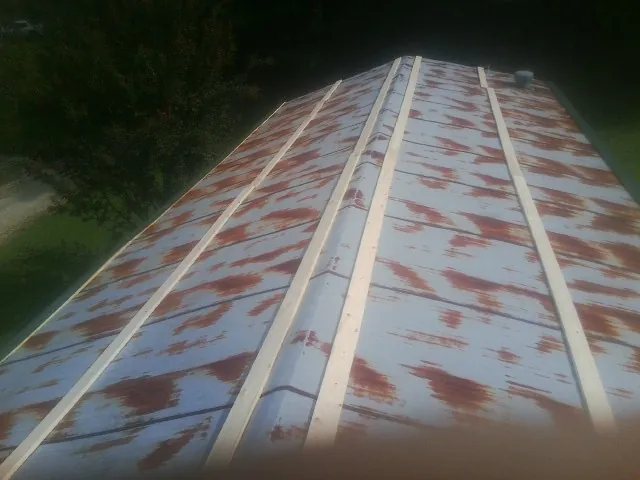 Rusted metal roof panels with new wood purlins before replacement — Storm Damage Roof Repair in Wassaic by Roofing Brothers