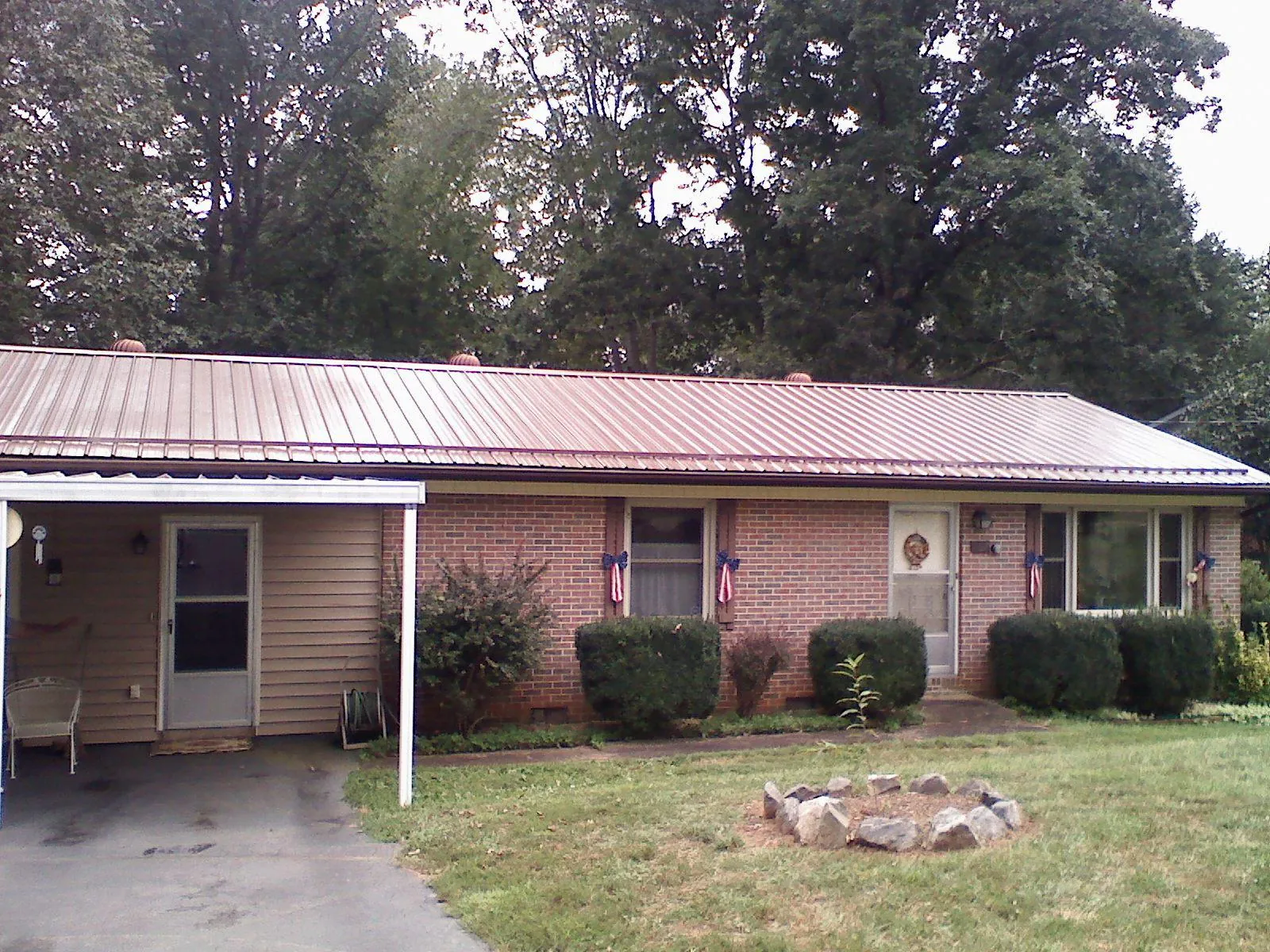 Bronze metal roof and carport on a brick ranch home — Roof Repair work by our crew in Wassaic
